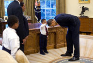 <p>"A temporary White House staffer, Carlton Philadelphia, brought his family to the Oval Office for a farewell photo with President Obama on May 8, 2009. Carlton's son softly told the President he had just gotten a haircut like President Obama, and asked if he could feel the President's head to see if it felt the same as his." (Pete Souza/The White House) </p>