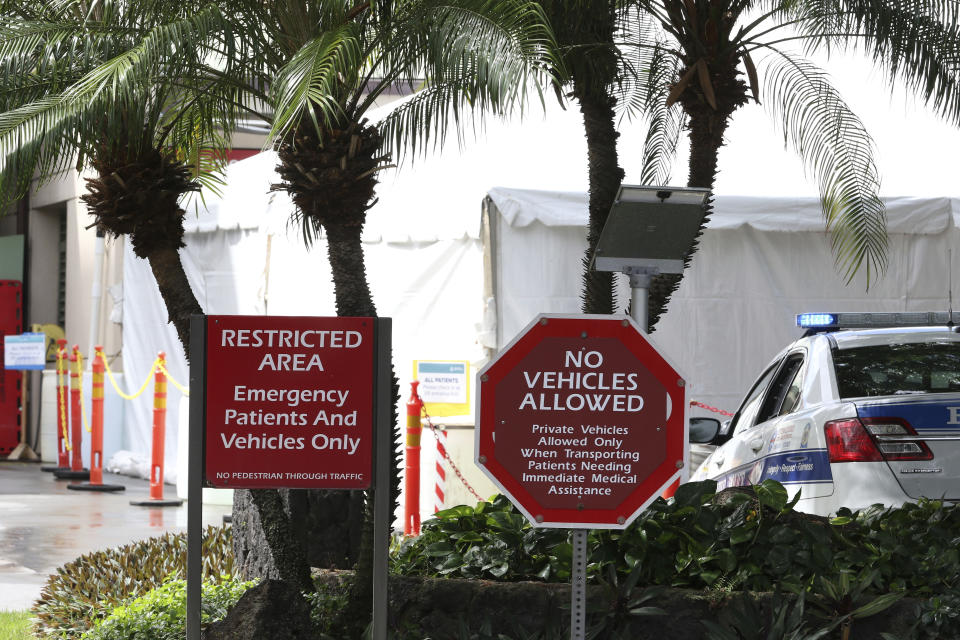 A tent is seen outside the emergency room at The Queen's Medical Center in Honolulu, Tuesday, Aug. 24, 2021. Hawaii was once seen as a beacon of safety during the pandemic because of stringent travel and quarantine restrictions and overall vaccine acceptance that made it one of the most inoculated states in the country. But the highly contagious delta variant exploited weaknesses as residents let down their guard and attended family gatherings after months of restrictions and vaccine hesitancy lingered in some Hawaiian communities.(AP Photo/Caleb Jones)