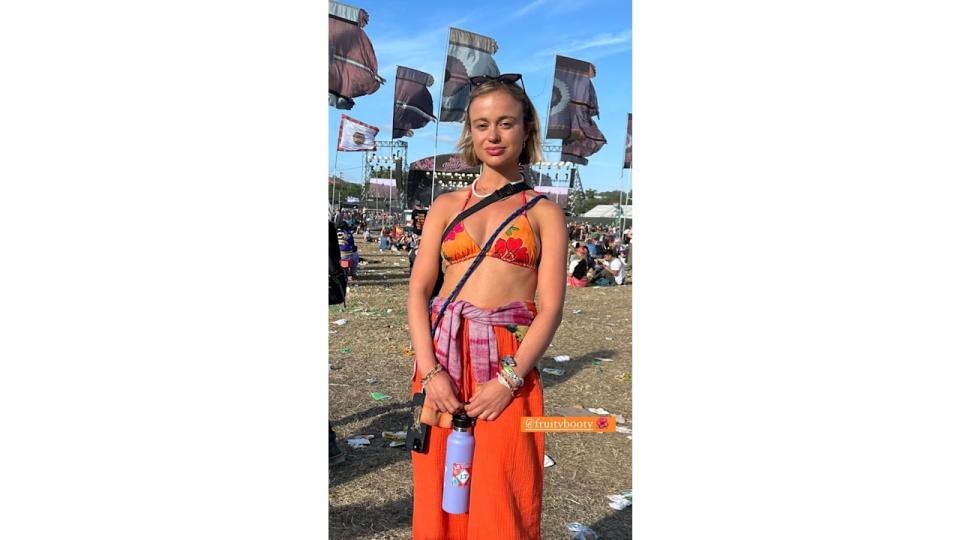 Amelia Windsor in a bikini top and orange trousers