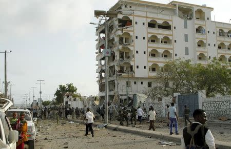 Somali government soldiers stand near the ruins of the Jazeera hotel after an attack in Somalia's capital Mogadishu, July 26, 2015. REUTERS/Feisal Omar