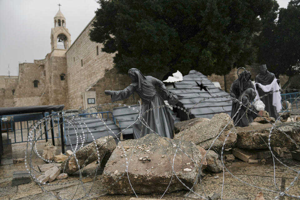 A nativity scene decorated to honor the victims in Gaza behind barbed wire. (Mahmoud Illean / AP)