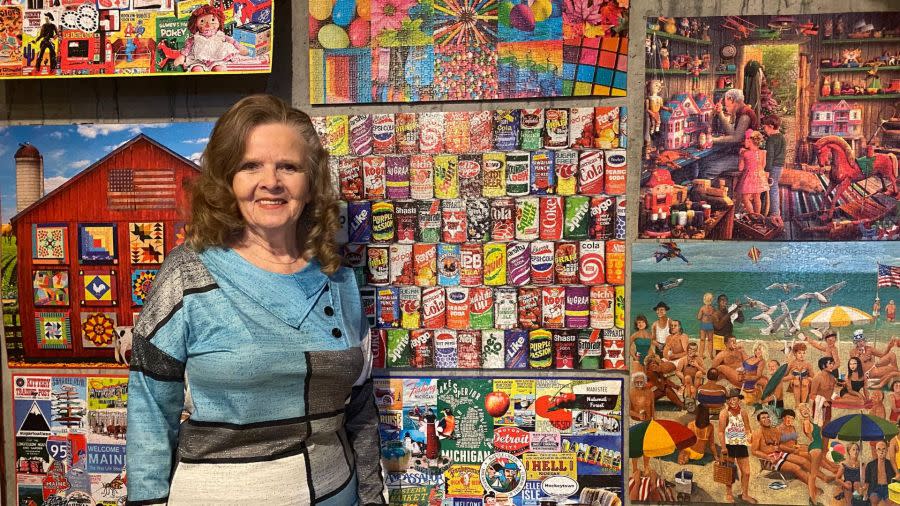 Barbara Lillis next to a couple of the puzzles in her collection