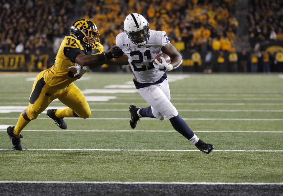 Iowa linebacker Djimon Colbert, left, loses his grasp of Penn State running back Noah Cain as Cain runs in for a touchdown during the second half of an NCAA college football game Saturday, Oct. 12, 2019, in Iowa City, Iowa. (AP Photo/Matthew Putney)