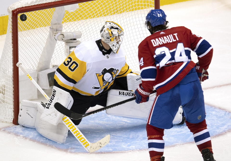 Montreal Canadiens centre Phillip Danault (24) watches as the puck bounces off the post behind Pittsburgh Penguins goaltender Matt Murray (30) during the third period of an NHL hockey playoff game Wednesday, Aug. 5, 2020 in Toronto. (Frank Gunn/The Canadian Press via AP)