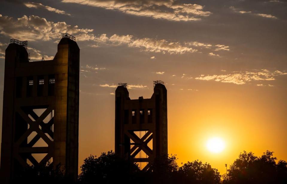 The sun sinks lower in the sky past the Tower Bridge in downtown Sacramento on Tuesday, Sept. 6, 2022.