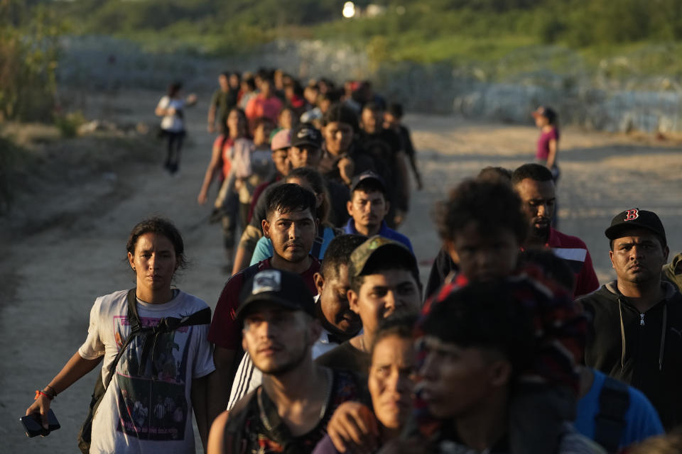 Migrants who crossed the Rio Grande and entered the U.S. from Mexico are lined up for processing by U.S. Customs and Border Protection, Saturday, Sept. 23, 2023, in Eagle Pass, Texas. (AP Photo/Eric Gay)