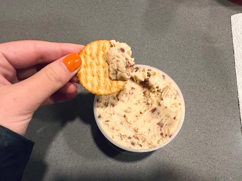 Trader Joe's Unexpected Cheddar cheese spread with a cracker