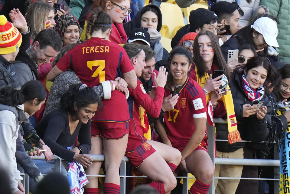 Spanish players celebrate with supporters following their extra time win at the Women's World Cup quarterfinal soccer match against the Netherlands in Wellington, New Zealand, Friday, Aug. 11, 2023. (AP Photo/Alessandra Tarantino)