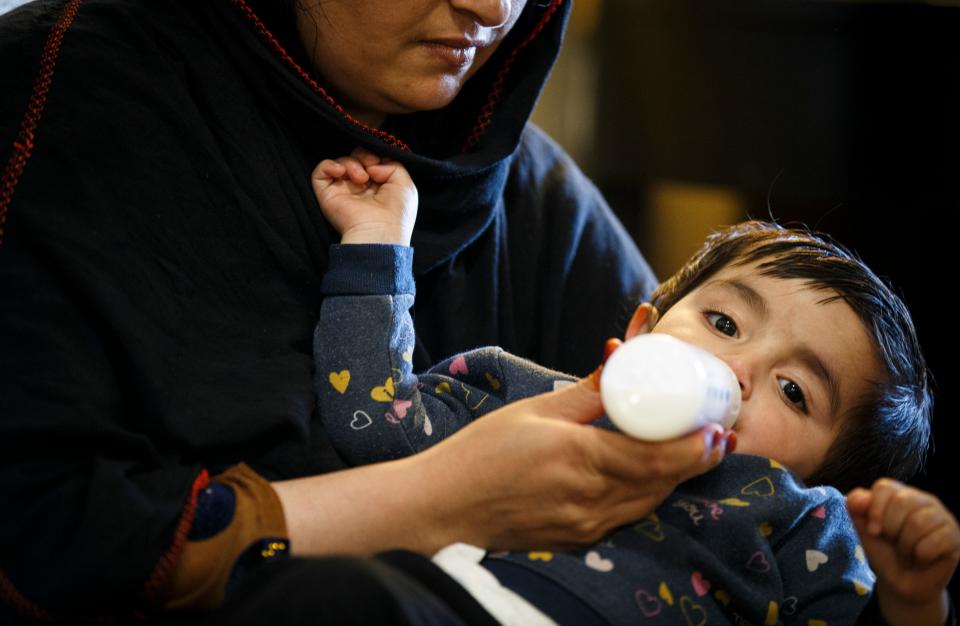 Hafisa Momand, an Afghan refugee, feeds her child at the Extended Stay America hotel in West Des Moines.