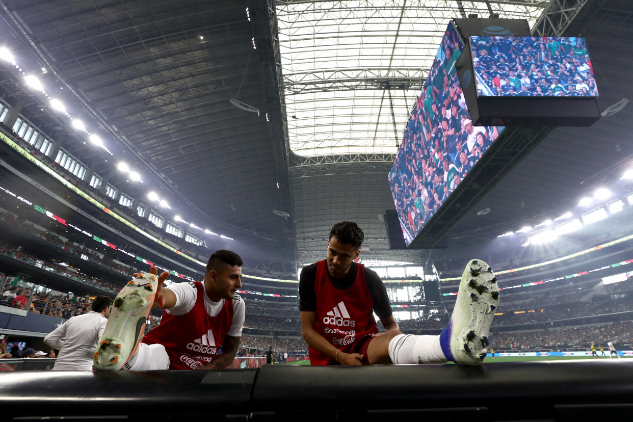 ARLINGTON, TEXAS - JUNE 09:  (L-R) Alexis Vega #27 and Diego Reyes #5 of Mexico warm up during a international friendly against Ecuador at AT&T Stadium on June 09, 2019 in Arlington, Texas. (Photo by Ronald Martinez/Getty Images)