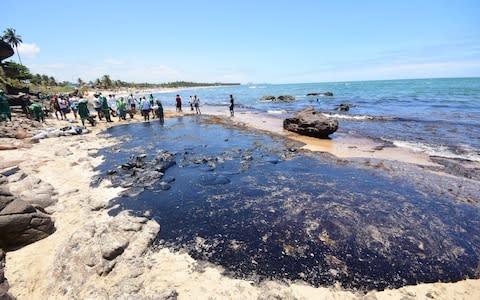 Volunteers attempt to clean the spill on Itapuama Beach in Cabo de Santo Agostinho - Credit: Veetmano Prem&nbsp;