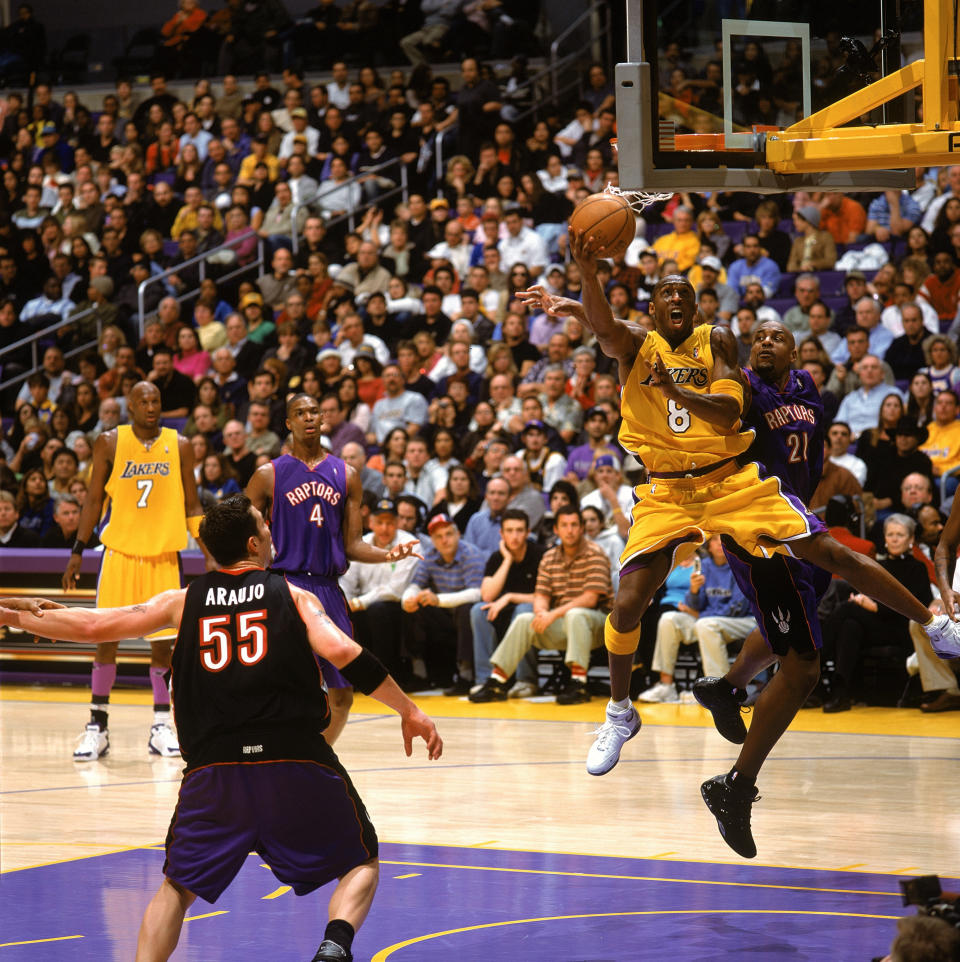 Bryant performs some acrobatics&nbsp;in the lane against Lamond Murray and the Toronto Raptors on Dec.&nbsp;28, 2004.