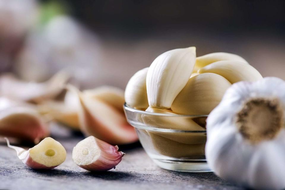 Fresh garlic on rustic wooden table.