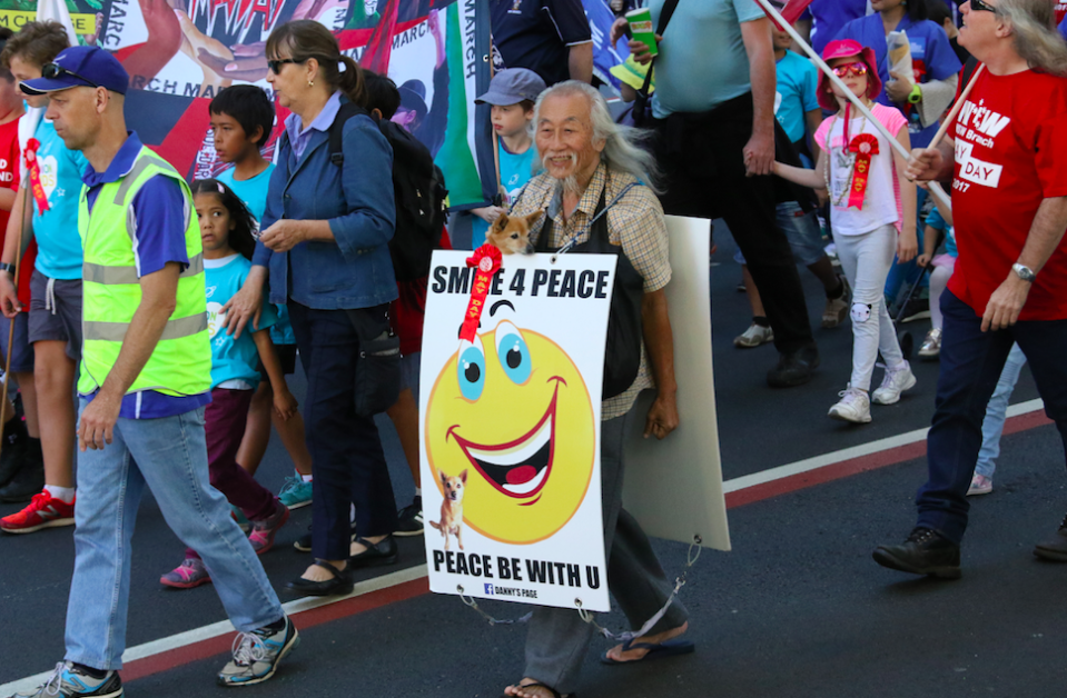 <em>Danny Lim (centre, carrying sign) wore a sandwich board that called the Australian prime minister the c-word (Rex)</em>