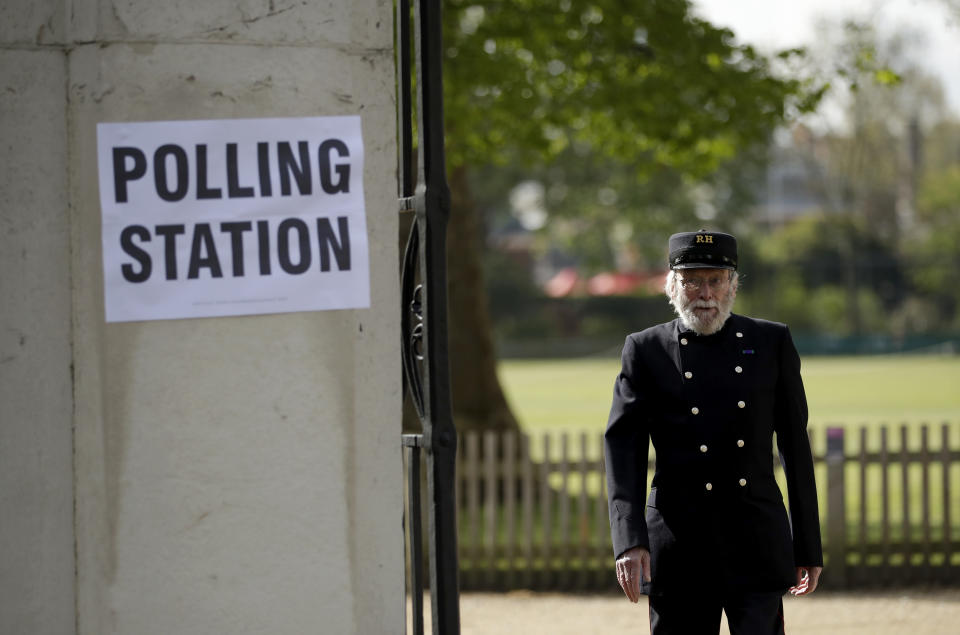 A Chelsea Pensioner walks past a sign for a polling station after voting in London, Thursday, May 6, 2021. Millions of people across Britain will cast a ballot on Thursday, in local elections, the biggest set of votes since the 2019 general election. A Westminster special-election is also taking place in Hartlepool, England. (AP Photo/Matt Dunham)