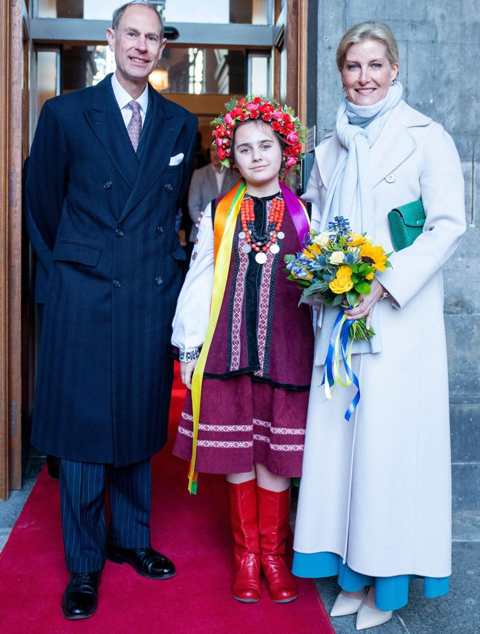 The new Duke and Duchess of Edinburgh, Britain's Prince Edward, Duke of Edinburgh (L) and Britain's Sophie, Duchess of Edinburgh (R) pose for a photograph with Marianna Melnyk, aged 10, from the Ukrainian community at the City Chambers in Edinburgh to mark one year since the city's formal response to the invasion of Ukraine on March 10, 2023. - Britain's King Charles III on Friday awarded his younger brother Edward the title Duke of Edinburgh, in line with the wishes of the late Queen Elizabeth II and her husband Prince Philip.