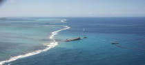 This photo provided by the French Defense Ministry shows oil leaking from the MV Wakashio, a bulk carrier ship that recently ran aground off the southeast coast of Mauritius,, Sunday Aug.9, 2020. The Indian Ocean island of Mauritius has declared a "state of environmental emergency" after the Japanese-owned ship that ran aground offshore days ago began spilling tons of fuel. (Gwendoline Defente/EMAE via AP)