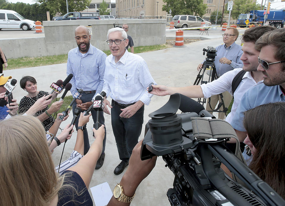 After winning their races in Wisconsin's primary elections Democratic candidate for governor Tony Evers, center right, and Democratic candidate for lieutenant governor Mandela Barnes talk with the media following their breakfast at Mickie's Dairy Bar in Madison, Wis., Wednesday, Aug. 15, 2018. (John Hart/Wisconsin State Journal via AP)