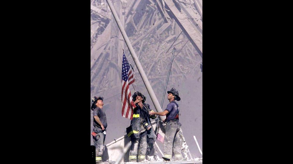 Firefighters raise a flag at Ground Zero following the attack on the World Trade Center on Sept. 11, 2001.