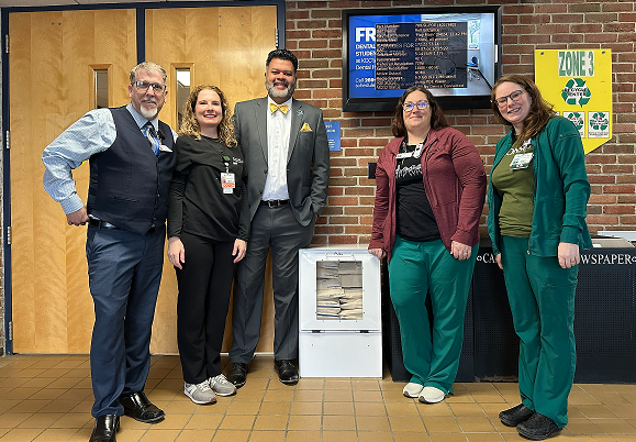 Bronson ED-MOUD Program Manager Paul Bodenberg, left, Emergency Physician Dr. Maureen McGlinchey Ford, Kellogg Community College President Paul Watson II, Emergency ED Manager of Bronson Battle Creek Hospital Kristin Visel and Trauma IP Coordinator of Bronson Methodist Hospital Christina Cameron showcase a new Narcan dispenser on the campus of Kellogg Community College.