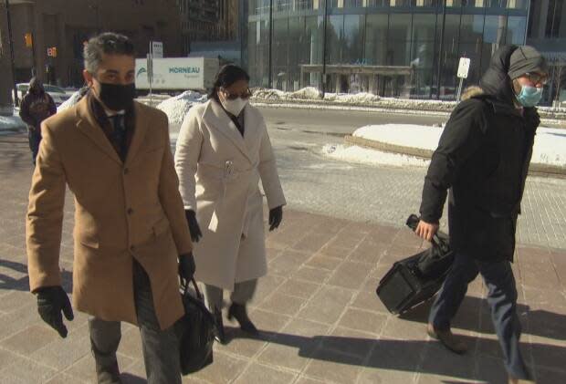 Aissatou Diallo, centre, appears at the Elgin Street courthouse in Ottawa with her defence lawyers Fady Mansour, left, and Solomon Friedman, right. (Francis Ferland/CBC - image credit)