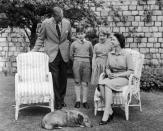 <p>Queen Elizabeth II, Prince Philip, Prince Charles, and Princess Anne relax with Sugar, the Queen's corgi. </p>