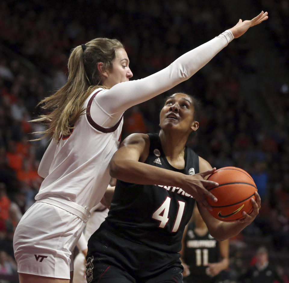 North Carolina State's Camille Hobby, right, looks to shoot while defended by Virginia Tech's Elizabeth Kitley (33) during the first half of an NCAA college basketball game Sunday, Feb. 19, 2023, in Blacksburg, Va. (Matt Gentry/The Roanoke Times via AP)