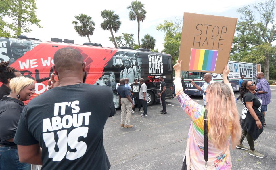 A crowd gathers around the Stay Woke Rolling Votercade buses, Friday June 23, 2023 as they arrive at the Allen Chapel AME Church in Daytona Beach.