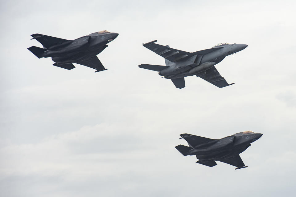 CORRECTS THE PHOTOGRAPHER TO CAYLEN MCCUTCHEON, NOT JUSTIN MCTAGGART - Aircraft from the aircraft carrier USS Nimitz and the USS Makin Island fly in formation past Nimitz in the South China Sea, Sunday, Feb. 12, 2023, as Nimitz and Makin Island with embarked 13th Marine Expeditionary Unit were conducting operations. The 7th Fleet based in Japan said Sunday that the USS Nimitz aircraft carrier strike group and the 13th Marine Expeditionary Unit have been conducting “integrated expeditionary strike force operations” in the South China Sea. (Mass Communication Specialist 3rd Class Caylen McCutcheon/U.S. Navy via AP)