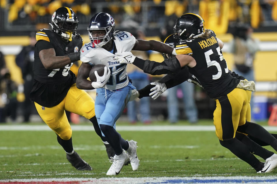 Tennessee Titans running back Tyjae Spears, center, runs the ball past Pittsburgh Steelers defensive end DeMarvin Leal, left and linebacker Cole Holcomb, right, during the first half of an NFL football game Thursday, Nov. 2, 2023, in Pittsburgh. (AP Photo/Matt Freed)