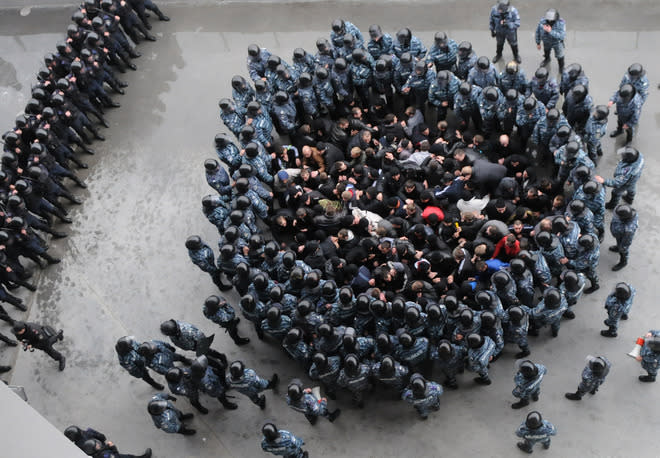 TOPSHOTS Riot policemen block "football hooligans" during an exercise at Arena Lviv stadium in western Ukrainian city of Lviv on April 19, 2012, in the network of preparation for EURO-2012. (Photo by Yuriy Dyachyshyn /AFP/Getty Images)