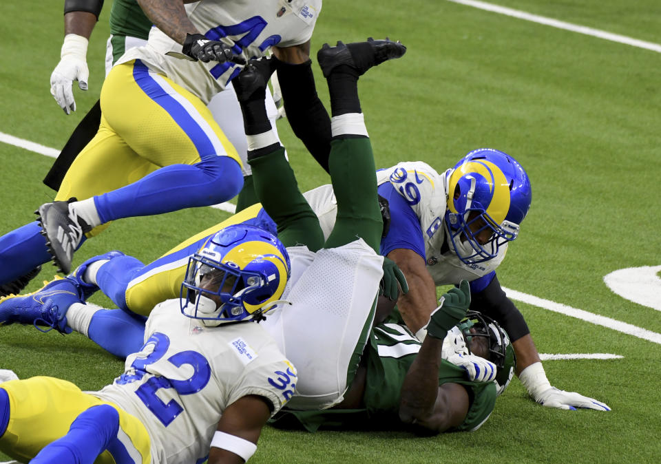 Los Angeles Rams defensive end Aaron Donald (99) tackles New York Jets running back Frank Gore (21) for a loss of yards in the first half of an NFL football game in Inglewood, Calif., Sunday, Dec. 20, 2020. (Keith Birmingham/The Orange County Register via AP)