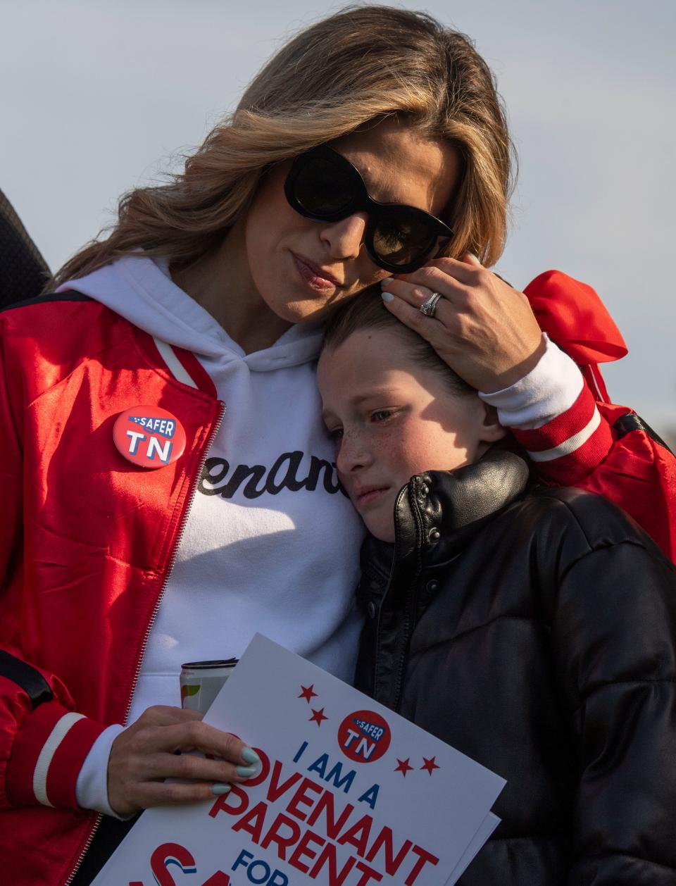 Mary Joyce comforts her daughter Monroe during the Linking Arms for Change event at Centennial Park in Nashville, Tenn., Wednesday, March 27, 2024. The event was in remembrance of the Covenant School shooting where six people — three children and three adults — were killed last year.