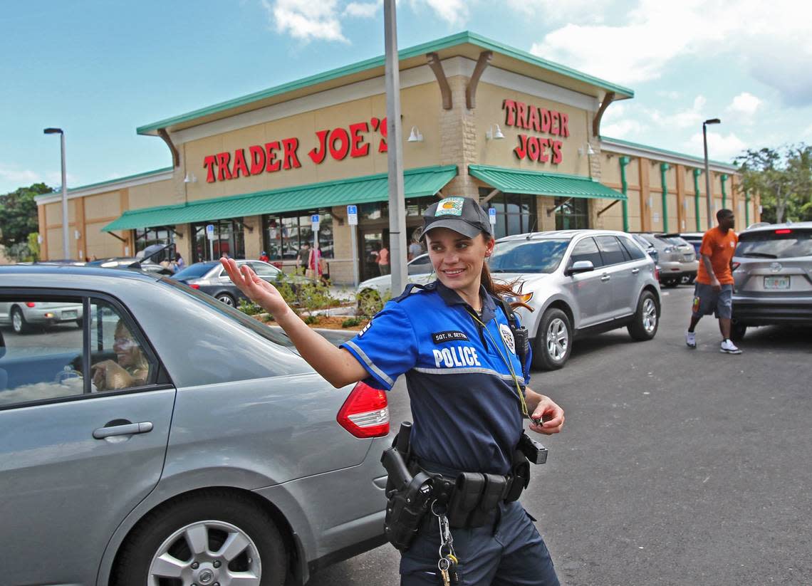 A Pinecrest officer helps shoppers jockey for parking spaces at the 2013 opening of Trader Joe’s, the first in South Florida.