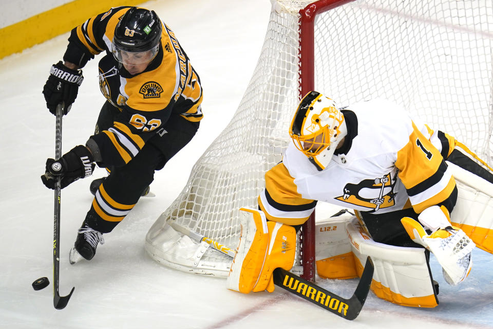Boston Bruins' Brad Marchand (63) can't get a wraparound past Pittsburgh Penguins goaltender Casey DeSmith during the first period of an NHL hockey game in Pittsburgh, Thursday, April 21, 2022. (AP Photo/Gene J. Puskar)
