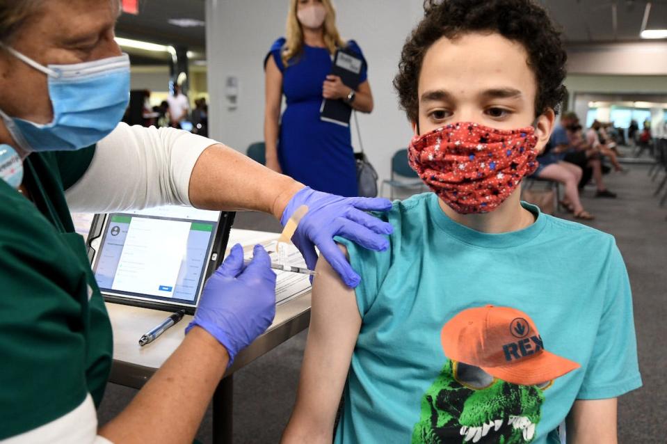 Malikai McPherson, 16, gets a shot of a COVID-19 vaccine in Florida.