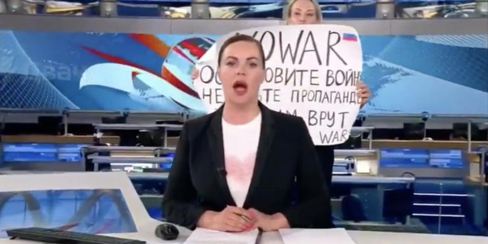An anti-war protestor interrupts a Russian-state TV broadcast