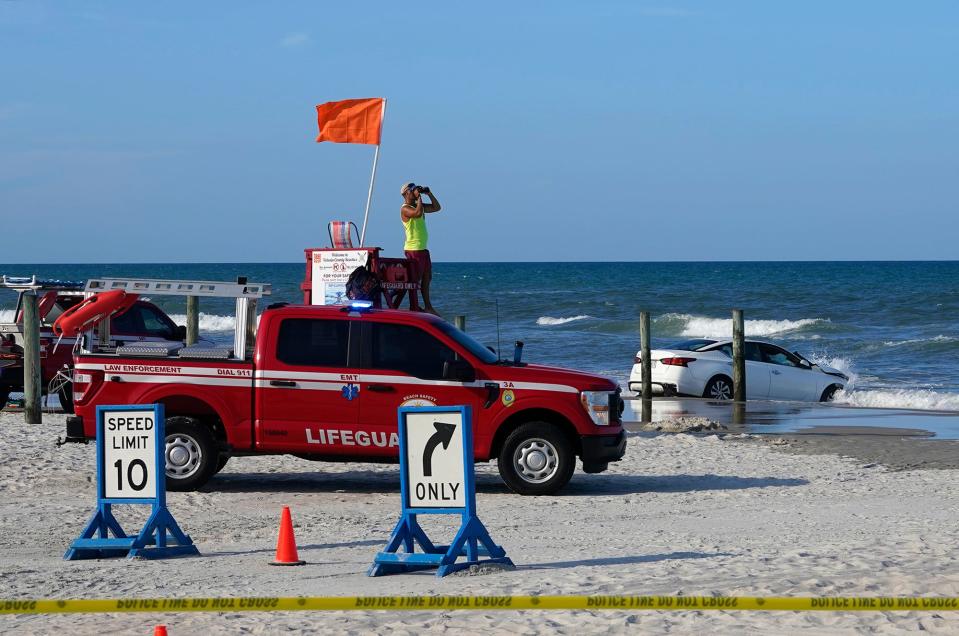 A car sits in the ocean after crashing through a beach toll booth in Dayton Beach, Sunday, July 24, 2022. 