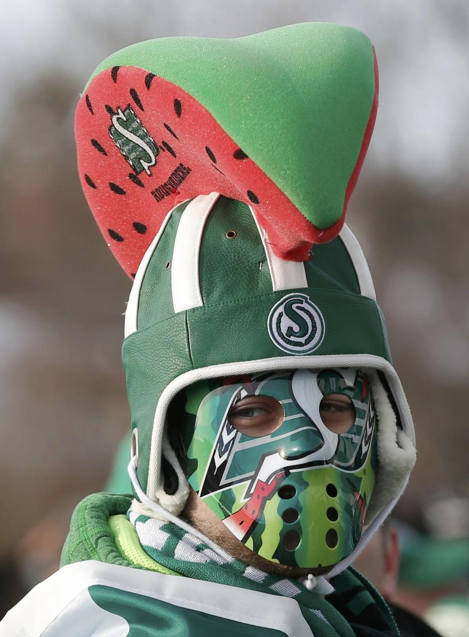 A Saskatchewan Roughrider fan gets ready outside the stadium for the 101st Grey Cup game between the Saskatchewan Roughriders and the Hamilton Tiger Cats in Regina