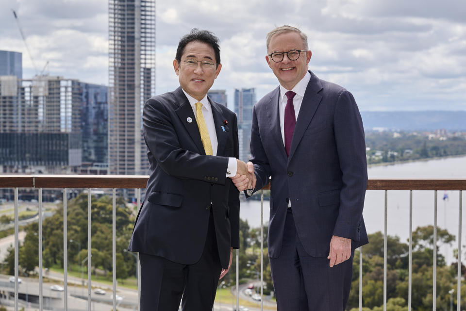 Japan's Prime Minister Fumio Kishida, left, shakes hands with Australian Prime Minister Anthony Albanese in Perth, Australia, Saturday, Oct. 22, 2022. Kishida is on a visit is to bolster military and energy cooperation between Australia and Japan amid their shared concerns about China. (Stefan Gosatti/Pool Photo via AP)