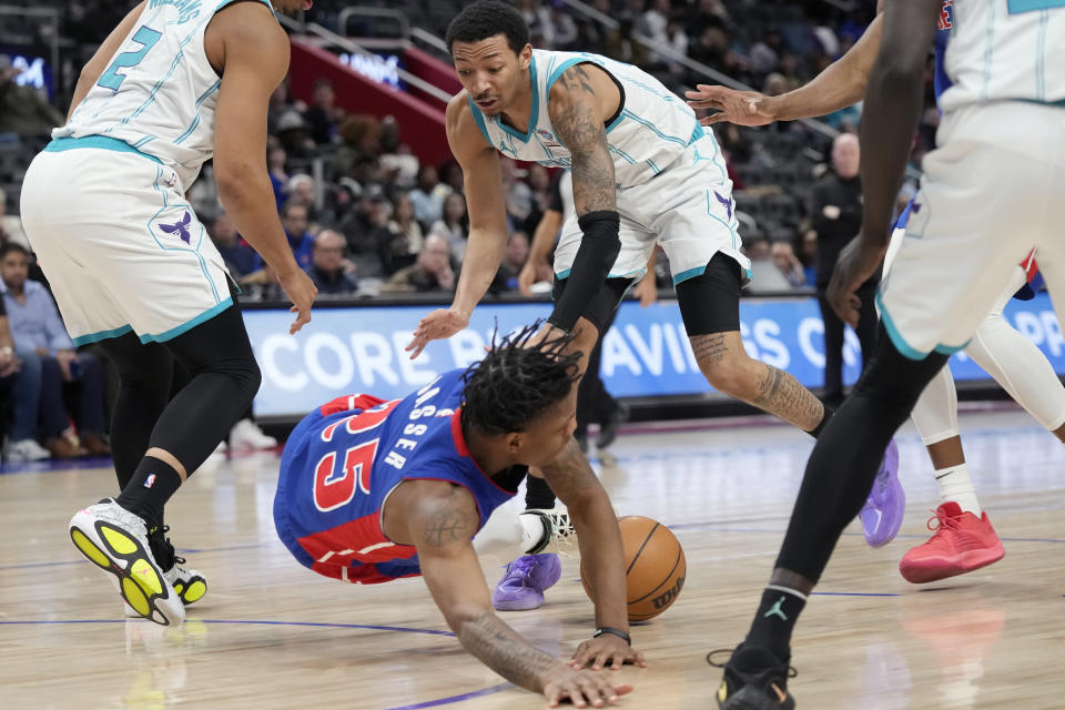 Charlotte Hornets guard Nick Smith Jr. (8) fouls Detroit Pistons guard Marcus Sasser (25) during the second half of an NBA basketball game, Monday, March 11, 2024, in Detroit. (AP Photo/Carlos Osorio)
