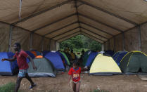 Tents are set up at a shelter for migrants in Lajas Blancas, Darien, Panama, Saturday, Oct. 23, 2021. A rising number of female migrants have reported suffering sexual abuse while crossing the treacherous Darien Gap between Colombia and Panama. Seeking to draw attention to the issue, a group of Panamanian lawmakers travelled Saturday on a fact-finding mission to speak with victims and authorities in the remote province. (AP Photo/Ana Renteria)