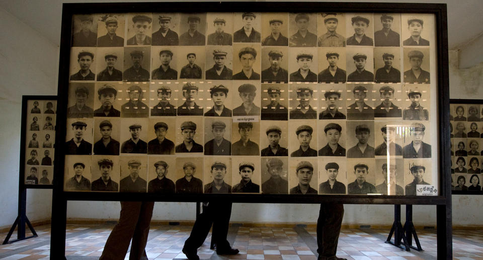 Tourists walk past hundreds of photographs of prisoners showcased in the classrooms of the Tuol Sleng Genocide Museum, also known as the notorious Security Prison 21 (S-21).