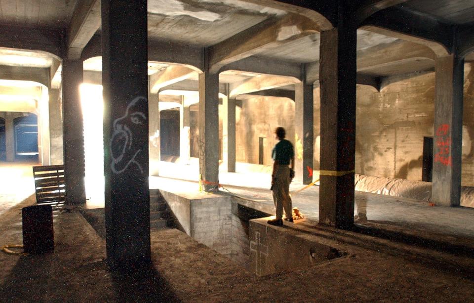 July 26, 2002: City of Cincinnati engineering technician John Luginbill looks at the subway station beneath Central Parkway at Race Street which looks much as it did when built in the early 1920s.