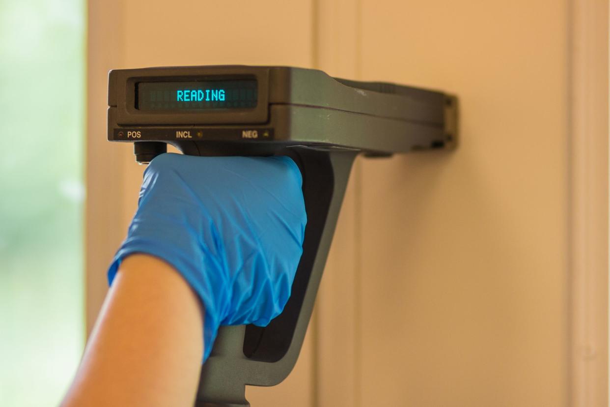 Using and XRF analyzer to test paint for lead during a home inspection.