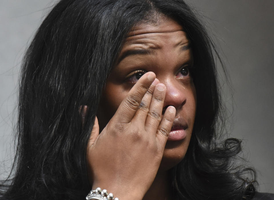 Ashley Smith wipes away tears as others talk about how she and others were mistreated recently at a Naperville, Ill. Buffalo Wild Wings restaurant. (Paul Valade/Daily Herald via AP) (Paul Valade/Daily Herald via AP)