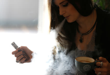 Lauren Poole of House of Vapes, uses a vape in London, Britain August 17, 2018. REUTERS/Peter Nicholls