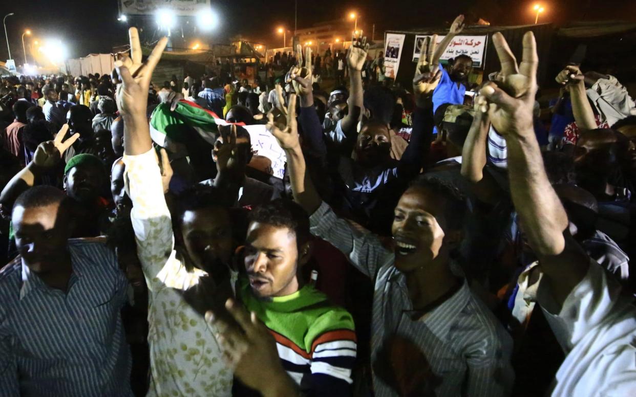 Sudanese civilians celebrate after the agreement was reached - AFP