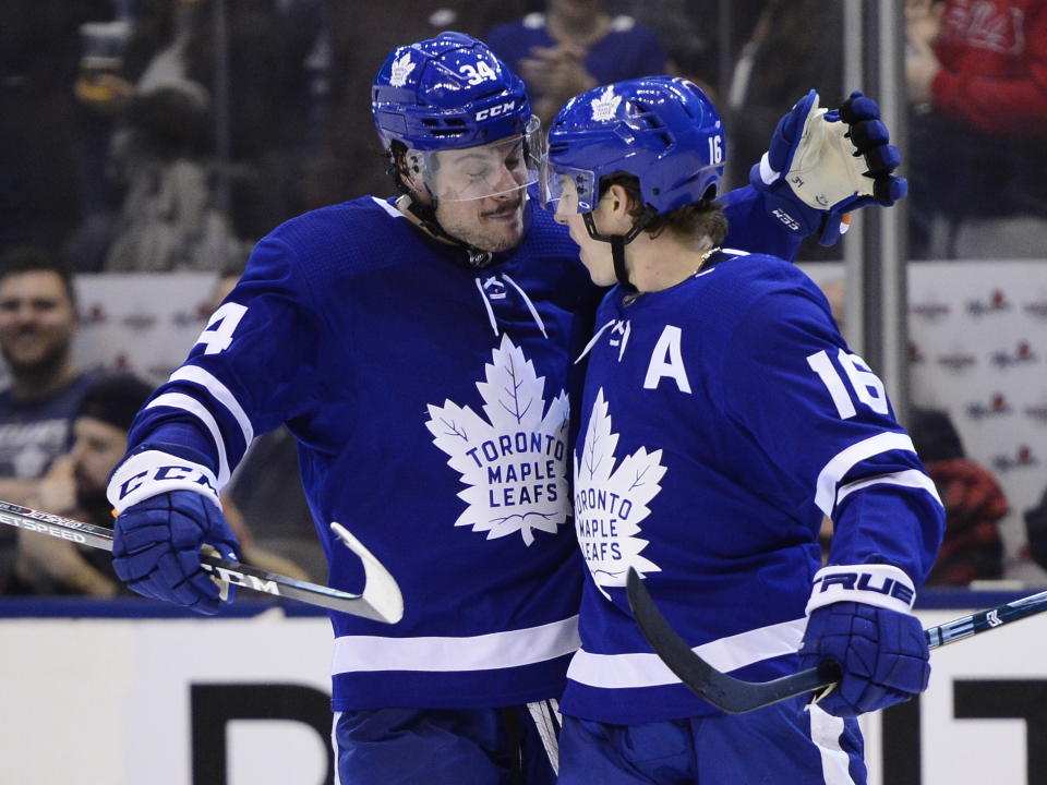 Toronto Maple Leafs right wing Mitch Marner (16) celebrates his second goal of the third period with teammate Auston Matthews (34) during NHL hockey action in Toronto, Monday, Dec. 23, 2019. (Frank Gunn/The Canadian Press via AP)