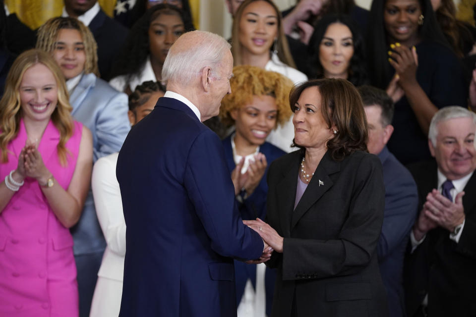 Vice President Kamala Harris holds hands with President Joe Biden after introducing him to speak during an event to honor the 2023 NCAA national champion LSU women's basketball team in the East Room of the White House, Friday, May 26, 2023, in Washington. (AP Photo/Evan Vucci)